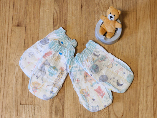 Potty training pull-up diaper and a toy potty with a teddy bear