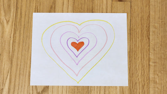 Paper drawing of concentric hearts, indicating the growth of kindness skills over time.