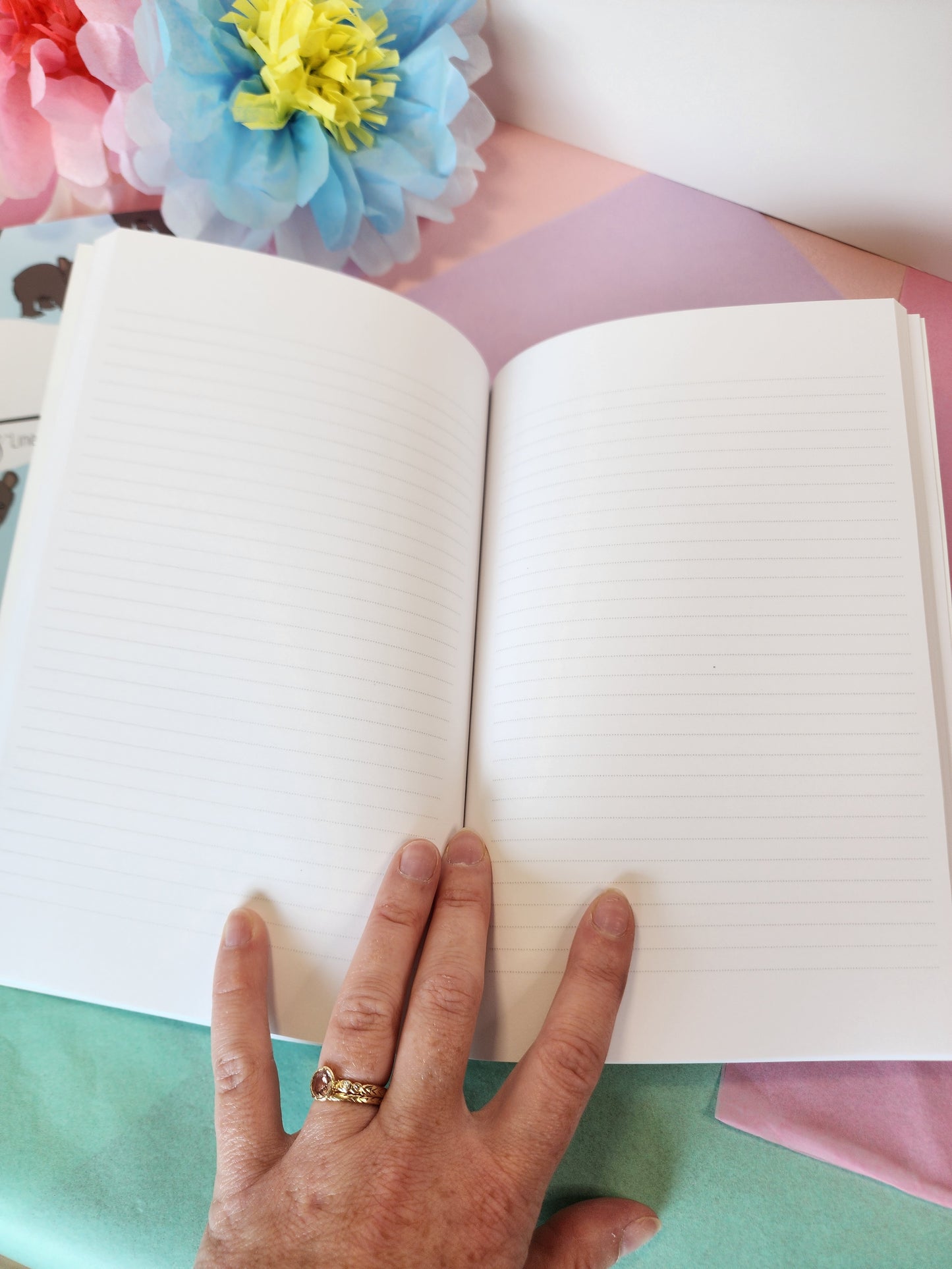 Mid-spread photo showing lined interior pages of the bear journal for writing, planning, or school use.
