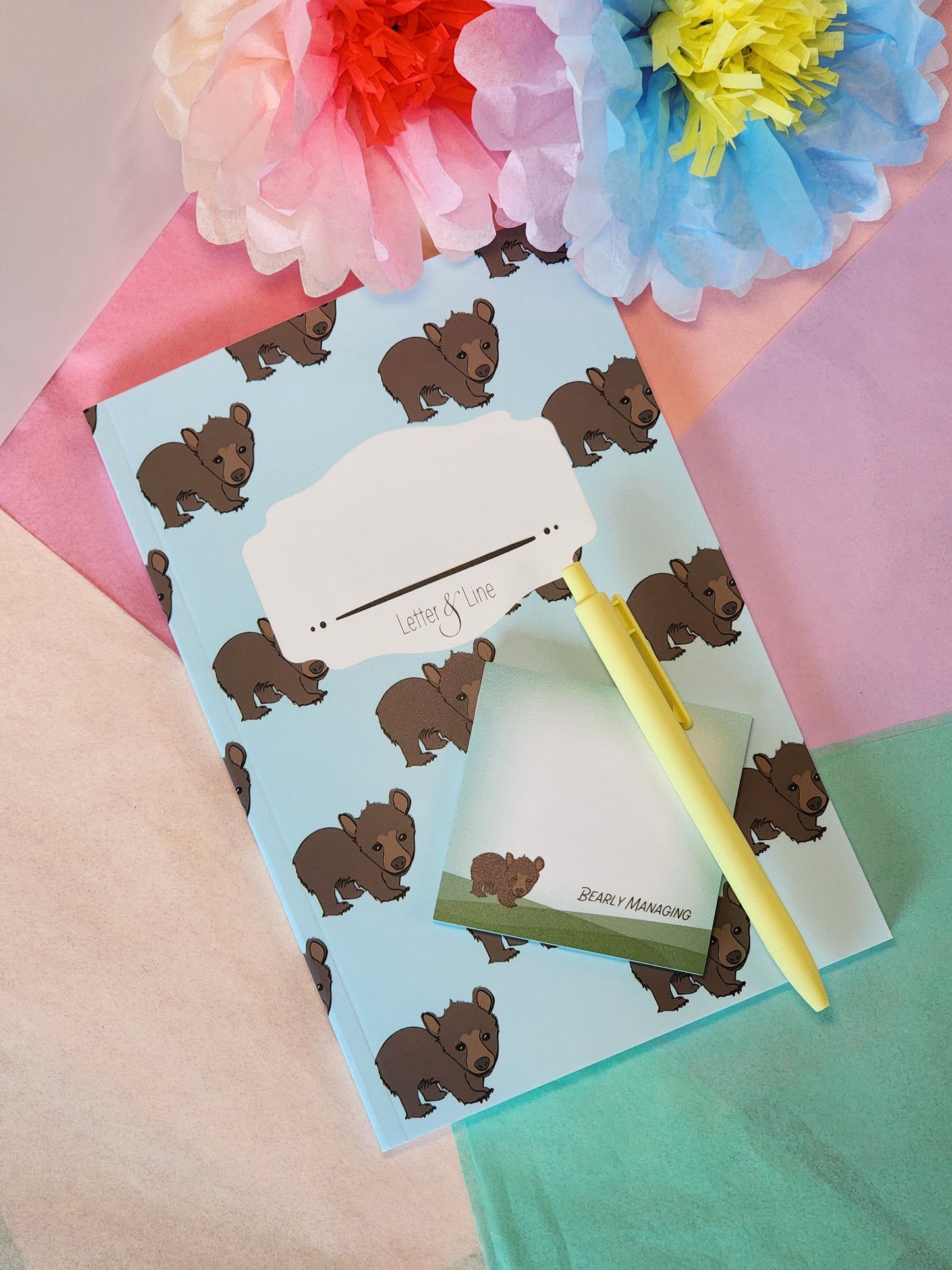Flat lay of Letter & Line bear notebook and pen, great for journaling or gift bundling.