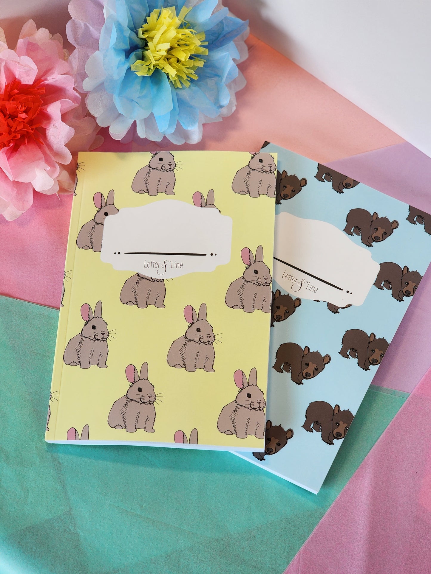 Yellow bunny notebook and blue bear notebook shown together for gift set comparison.