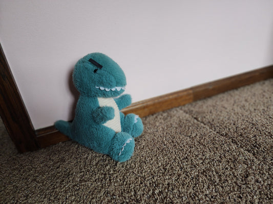 A toddler's angry dinosaur stuffed animal