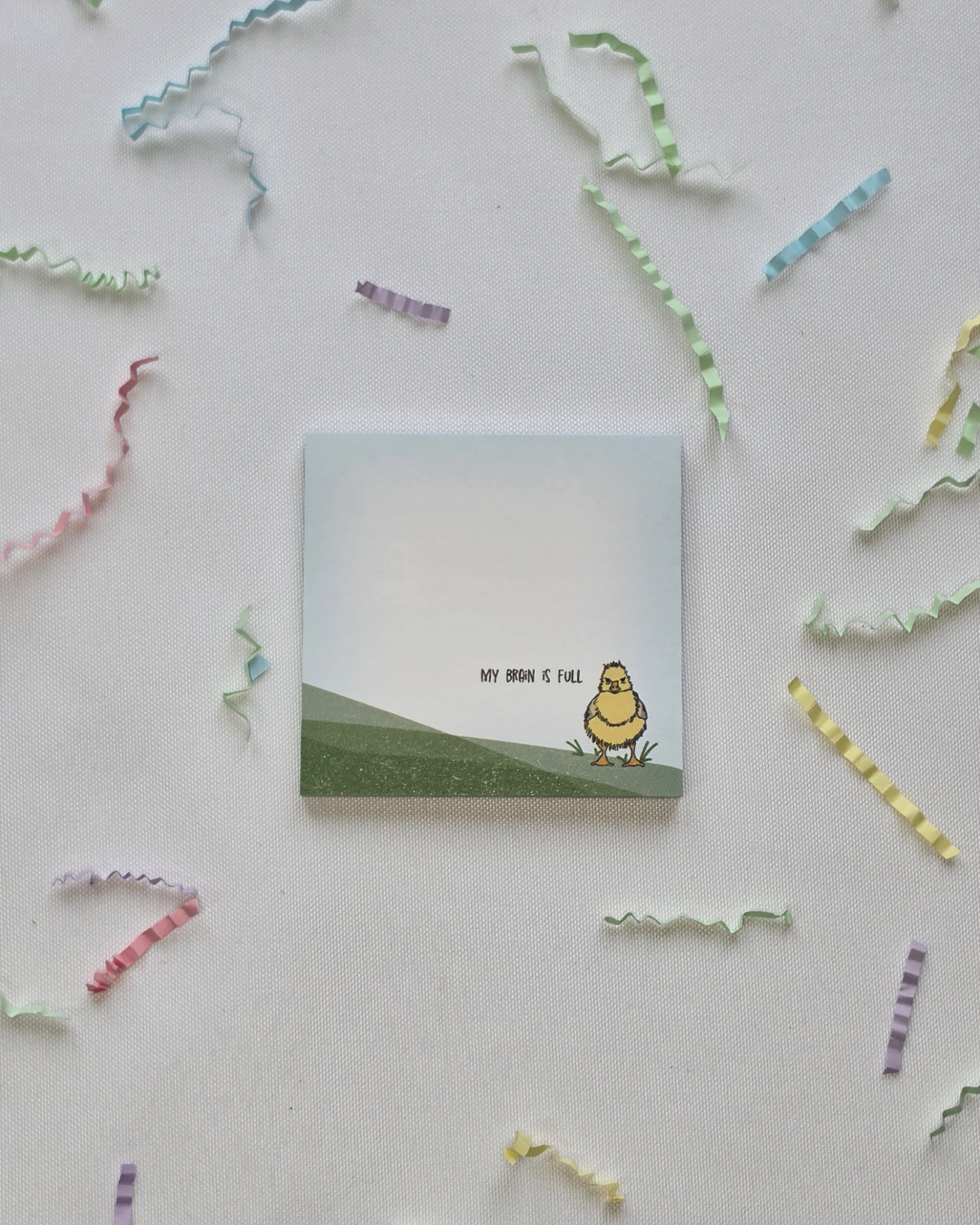 My Brain is Full duck Post-it Note pad flat lay with scattered colorful paper strips