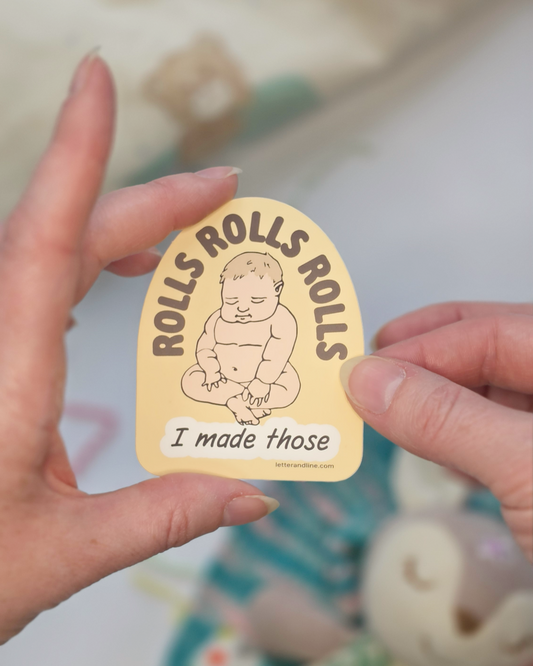 Hand holding Rolls Rolls Rolls I Made Those new parent milestone sticker showing illustrated chubby baby design