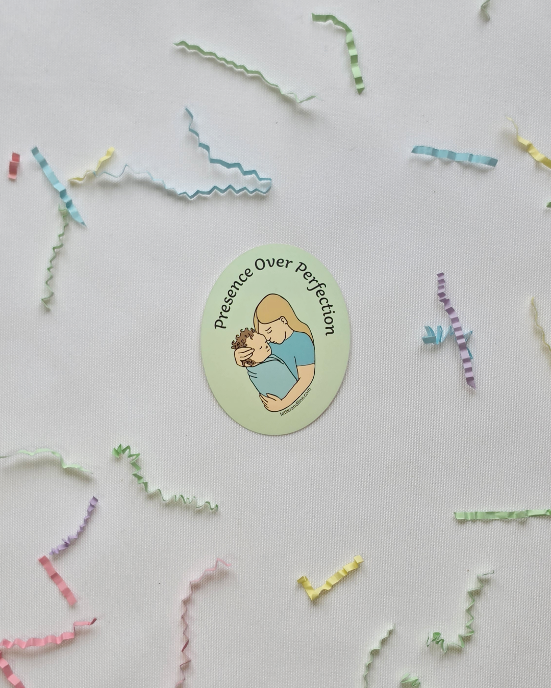 Presence Over Perfection new parent milestone sticker flat lay with scattered colorful paper strips