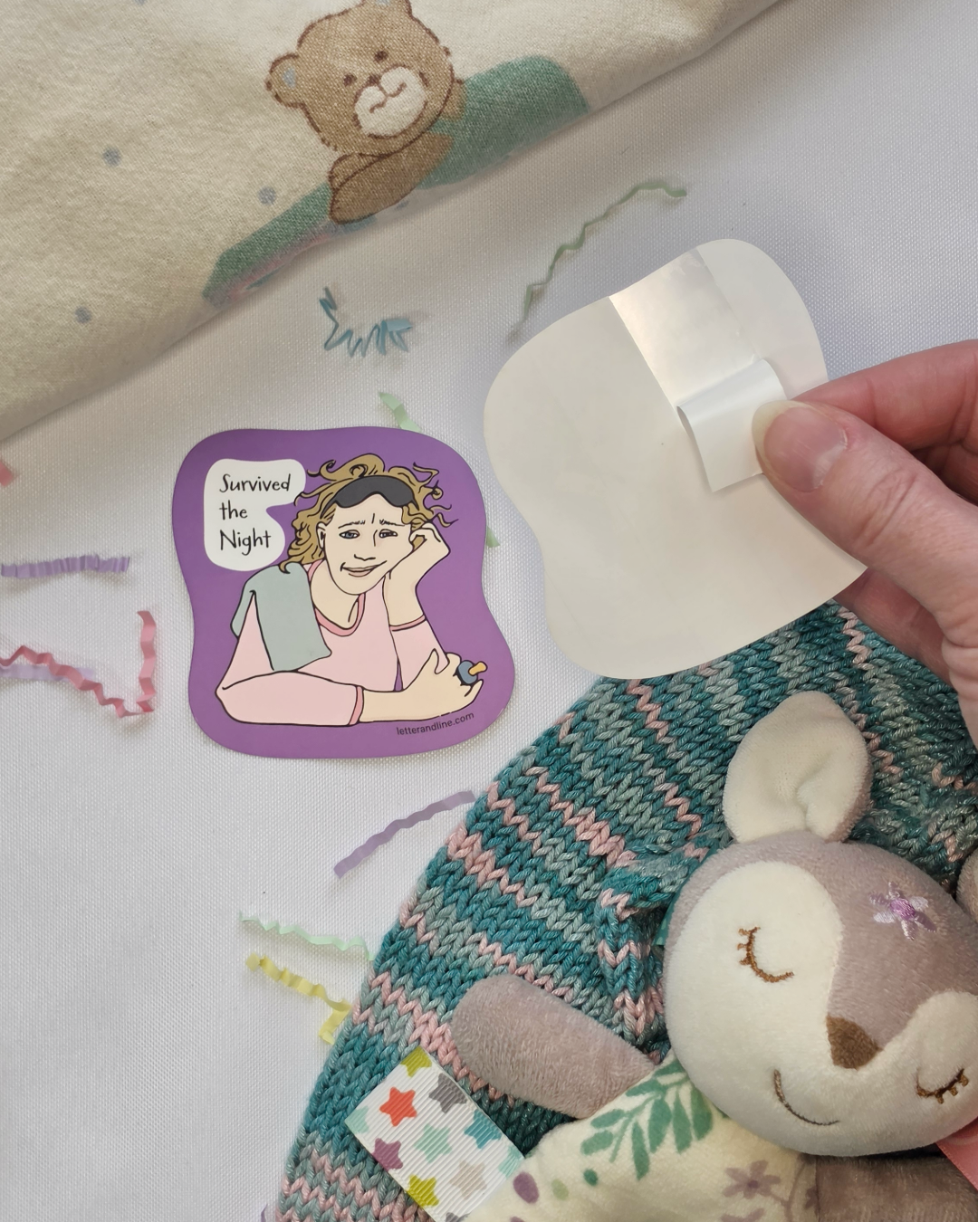 Survived the Night milestone sticker shown with split backing being peeled for easy application