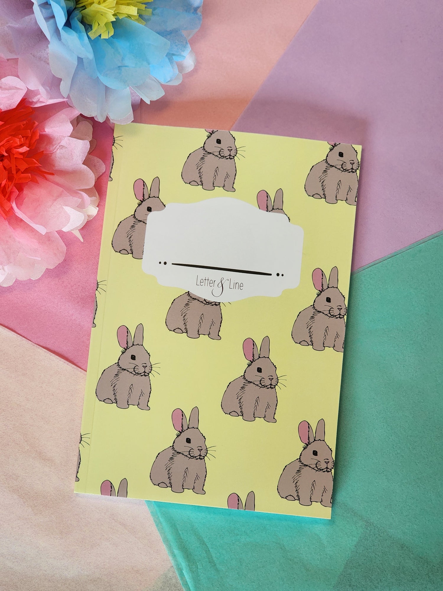 Cute bunny notebook with yellow cover shown against colorful background, perfect for journaling and back-to-school gifts.
