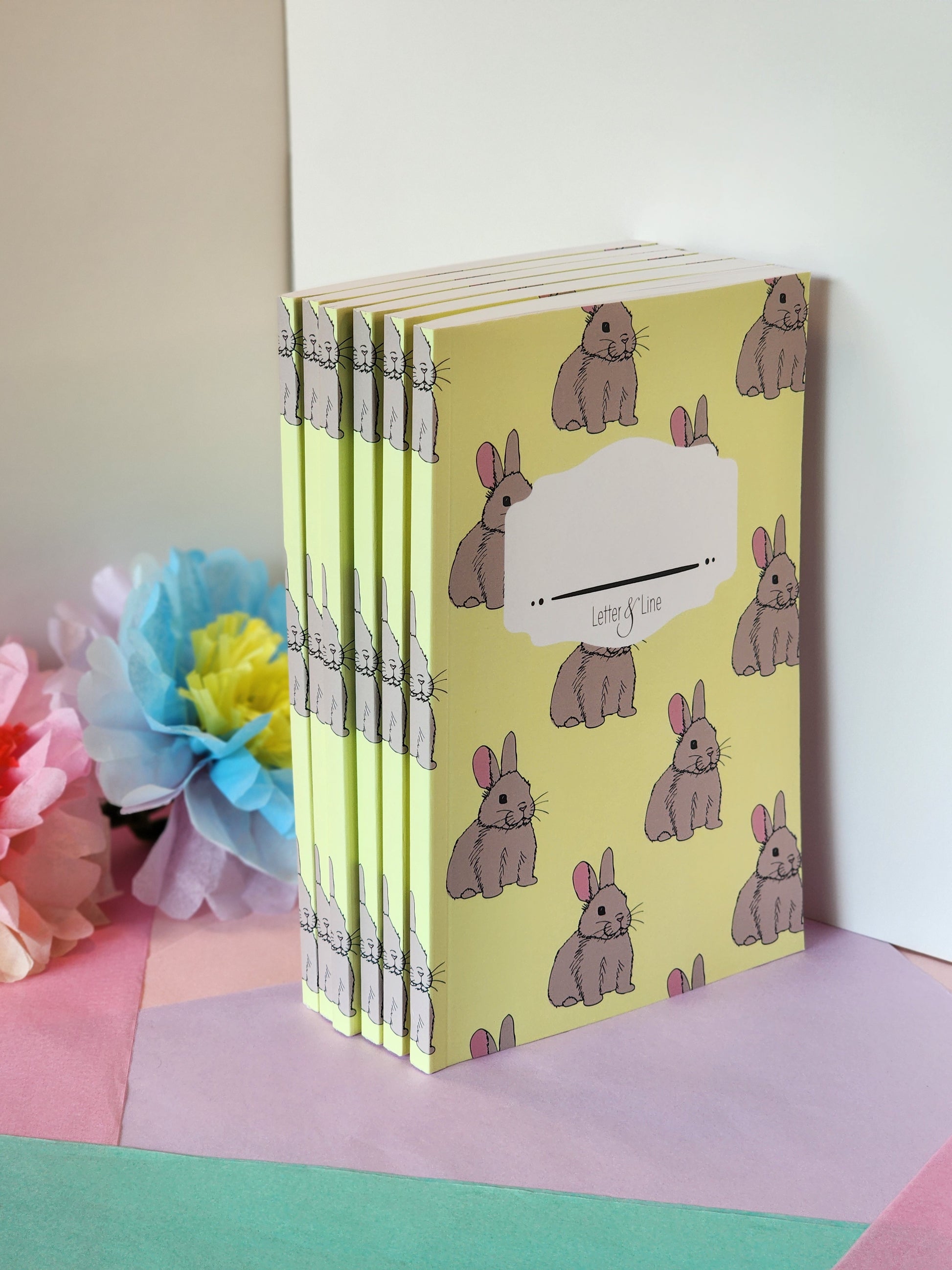 Multiple bunny notebooks stacked together, showcasing soft matte cover and slim design.