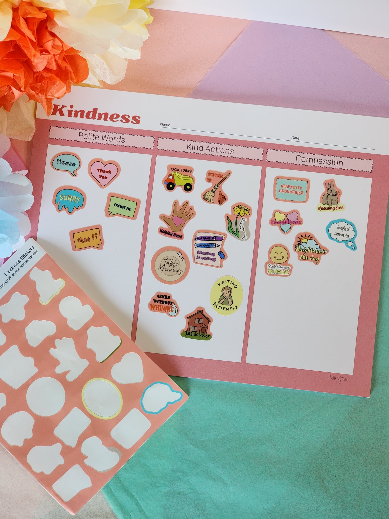 Kindness chart in use with colorful stickers added to each category to track positive behavior.