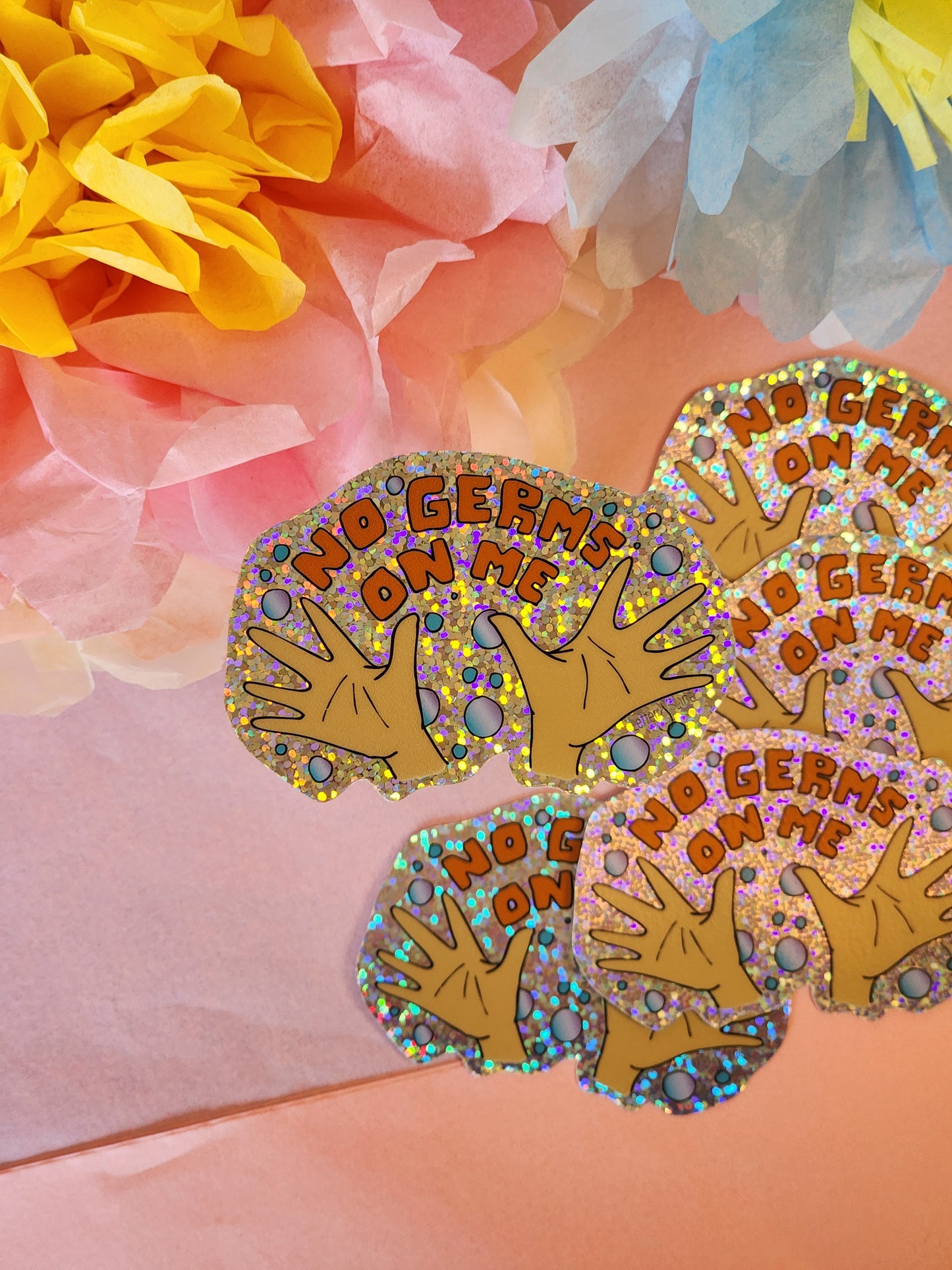 Multiple “No Germs on Me” hygiene achievement stickers with tissue paper flowers in pink, yellow, and blue tones.