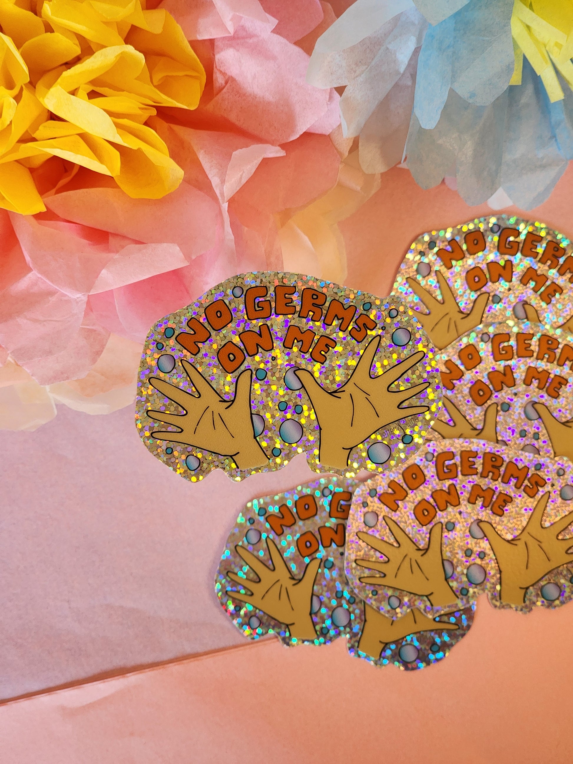 Multiple “No Germs on Me” hygiene achievement stickers with tissue paper flowers in pink, yellow, and blue tones.