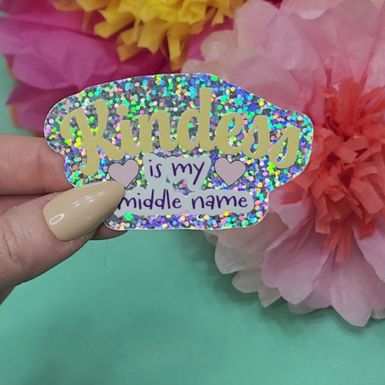 video showing the kindness is my middle name sticker sparkling in the light