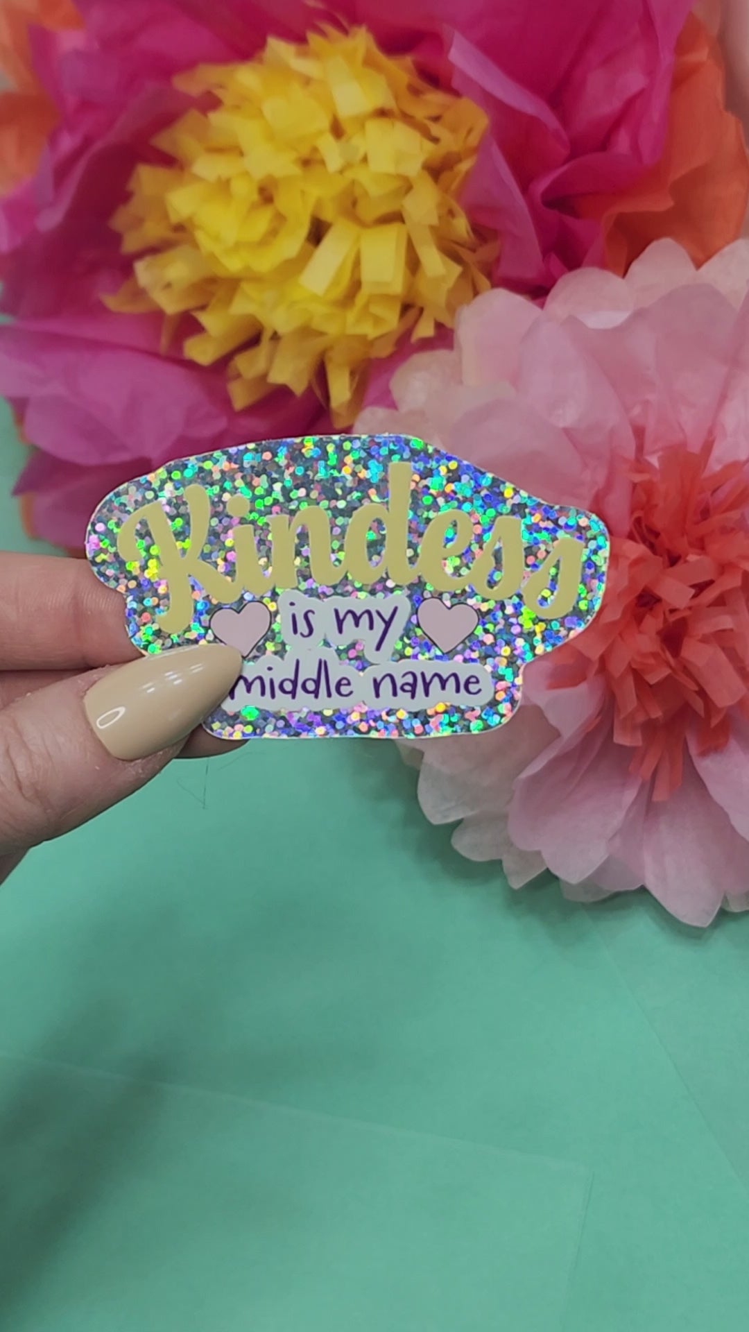 video showing the kindness is my middle name sticker sparkling in the light